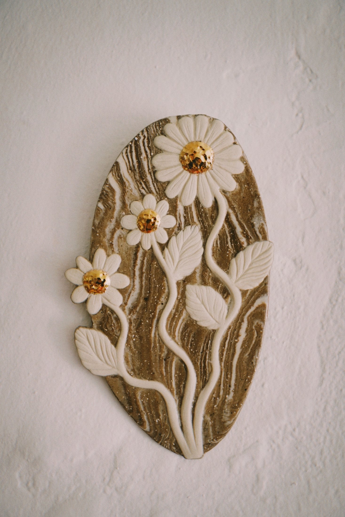 Carved ceramic wall plaque by Tantri Mustika