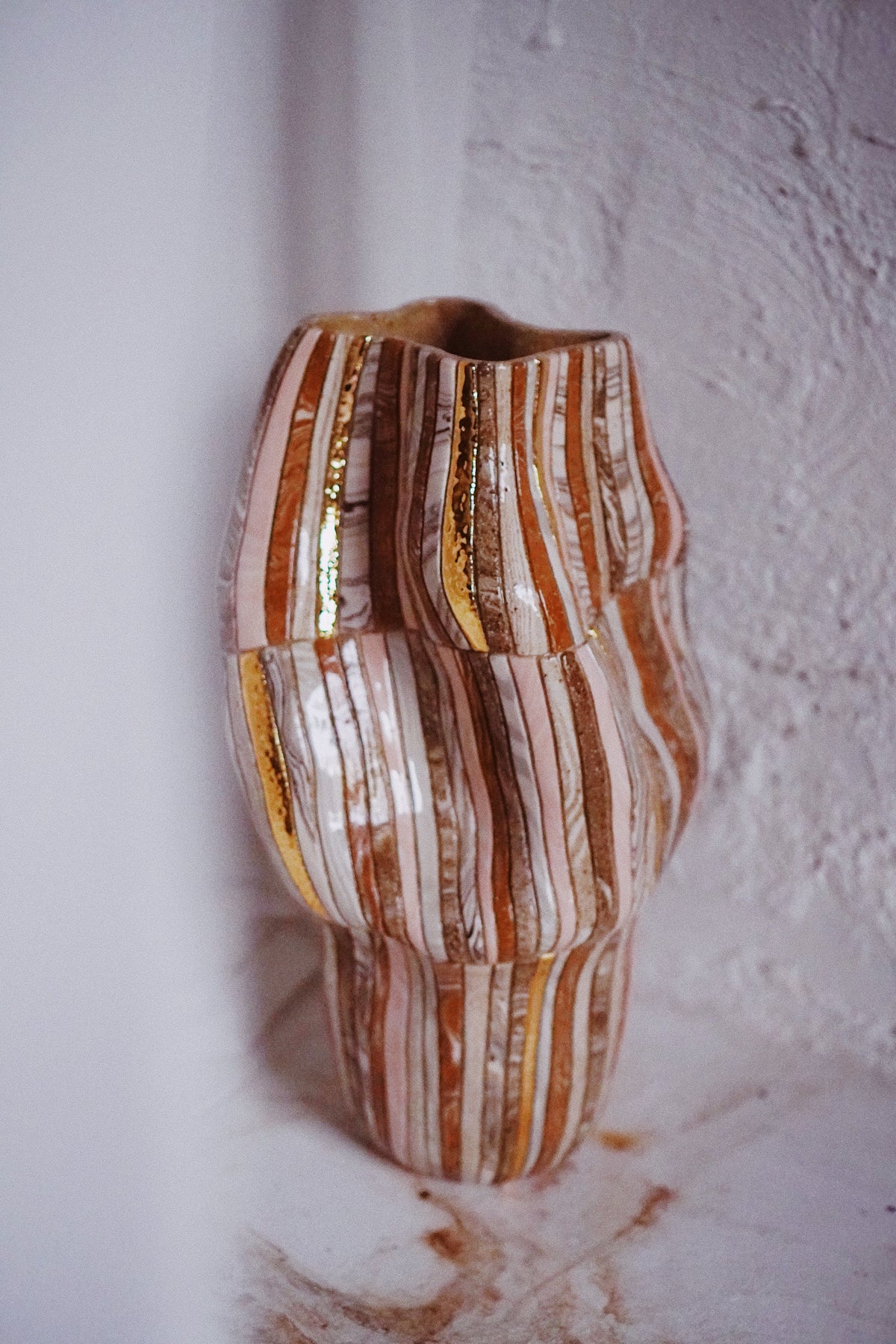 Striated vessel in blush and copper, Marmoreal, by Tantri Mustika