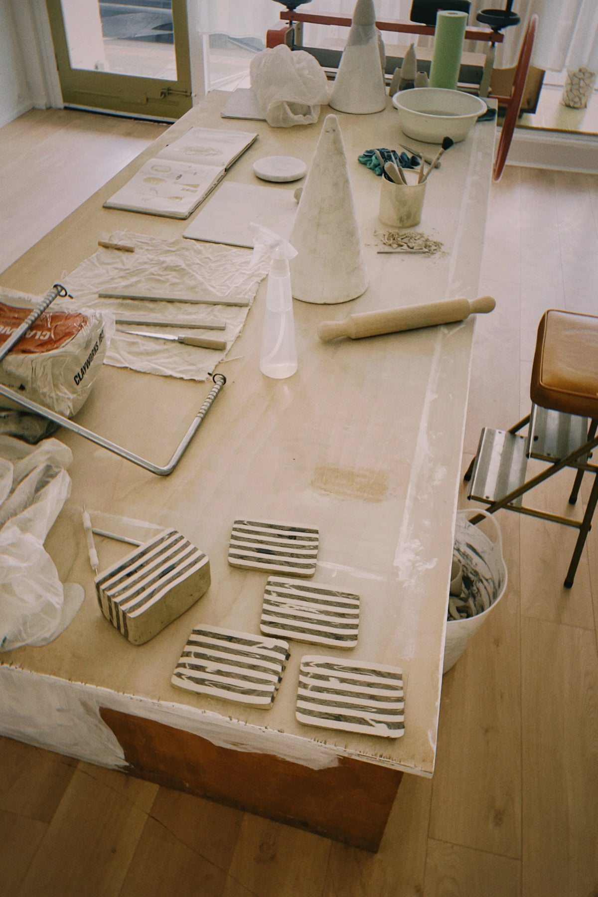 The worktable: striped slabs and forms in progress, in Tantri Mustika’s studio