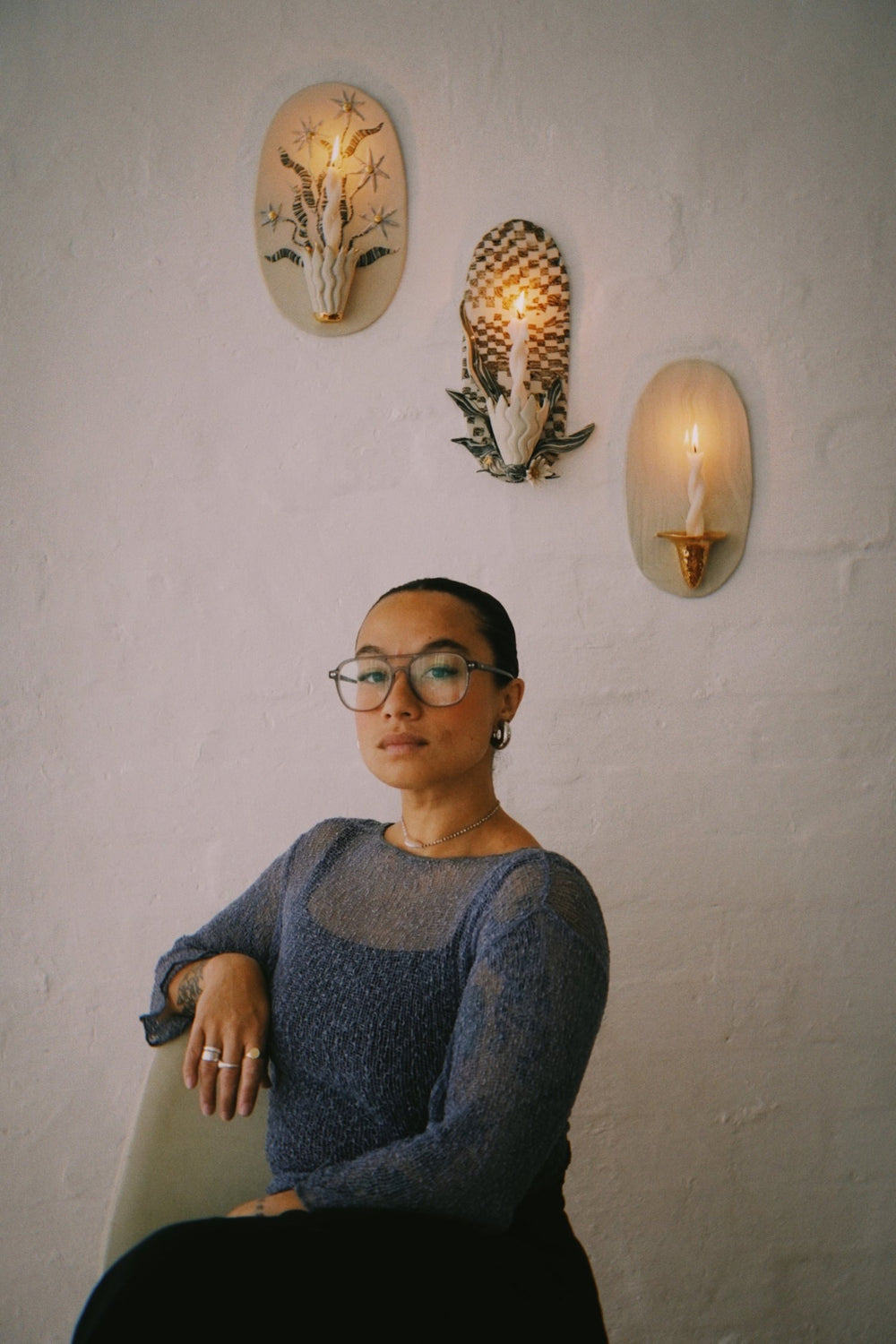 Tantri Mustika beneath her ceramic wall lights, from Hunter & Folk