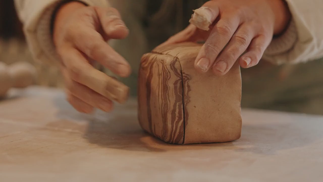 Tantri Mustika marbling, carving and coiling clay in her Carnegie studio