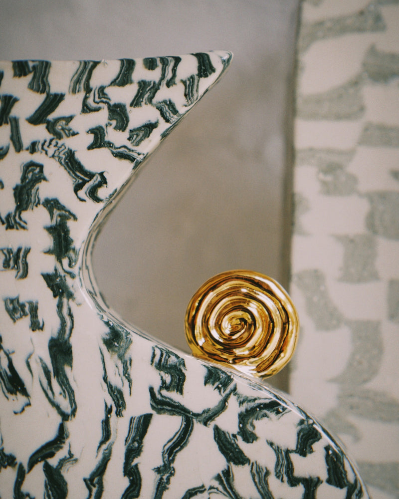 Detail of a nerikomi vase by Tantri Mustika: green and white layered clay with a gold lustre spiral