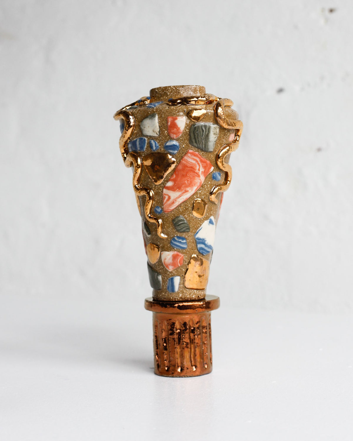 Vessel by Tantri Mustika inlaid with coloured clay fragments and wrapped in a gold lustre serpent, The Curiosities 2019