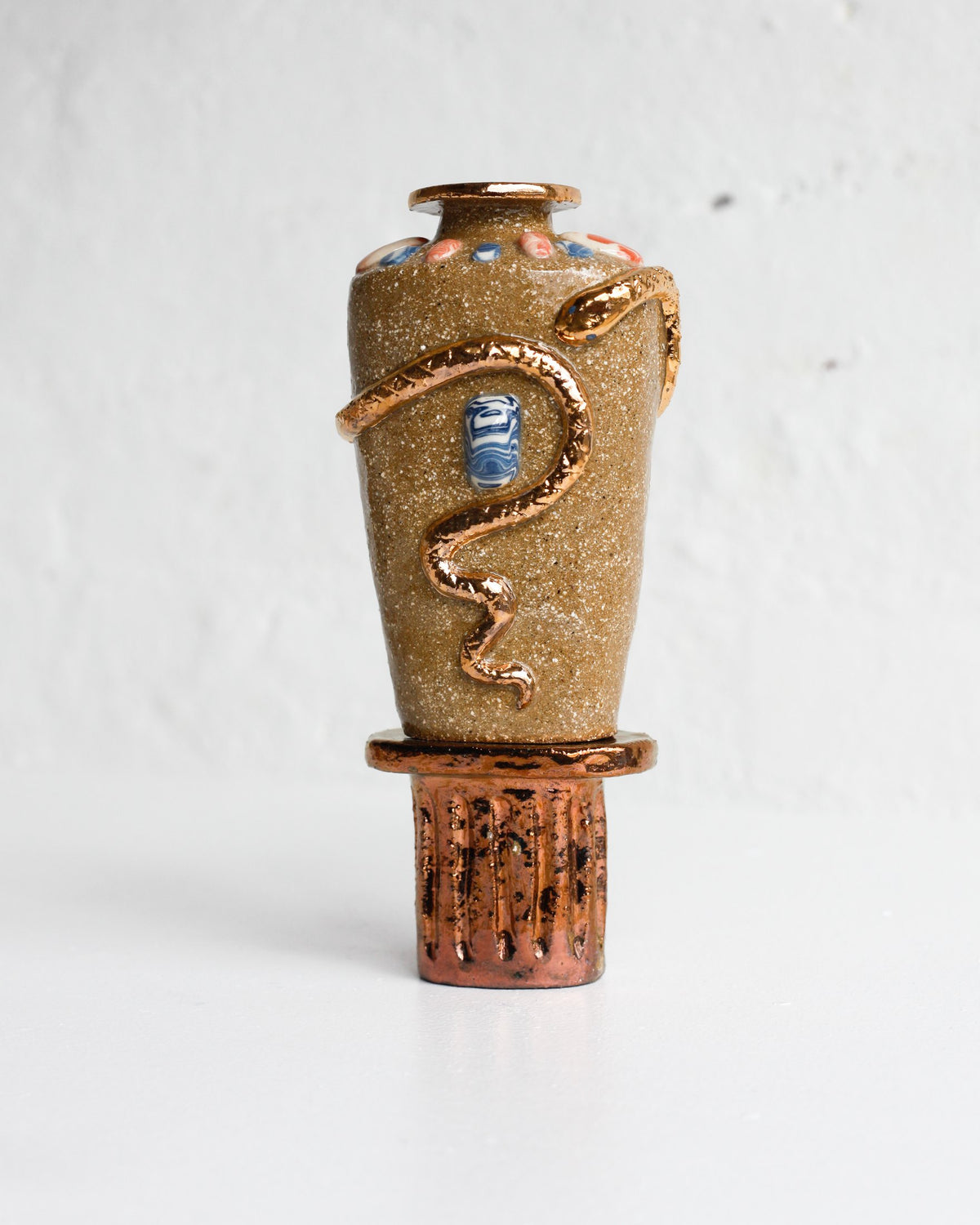Sandy stoneware vessel by Tantri Mustika with a gold lustre serpent, on a lustred stand, The Curiosities 2019