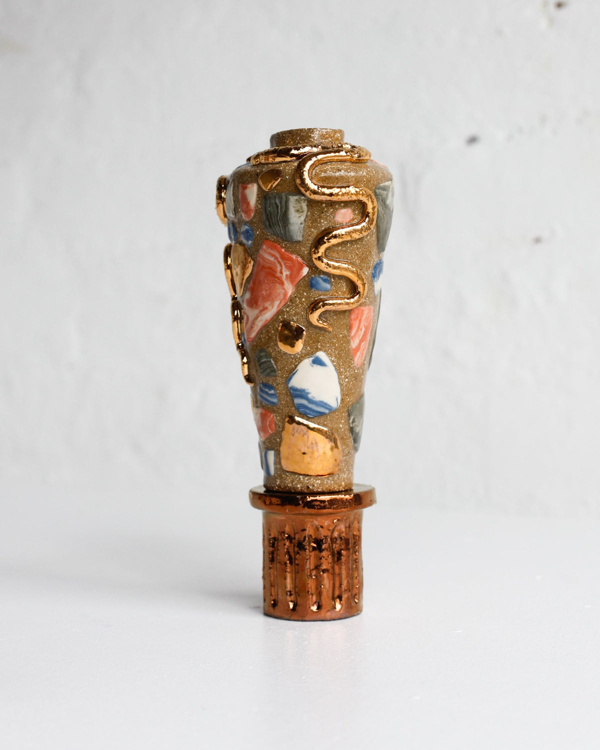 Side view of the serpent vessel by Tantri Mustika, inlaid with coloured clay and gold lustre, The Curiosities 2019