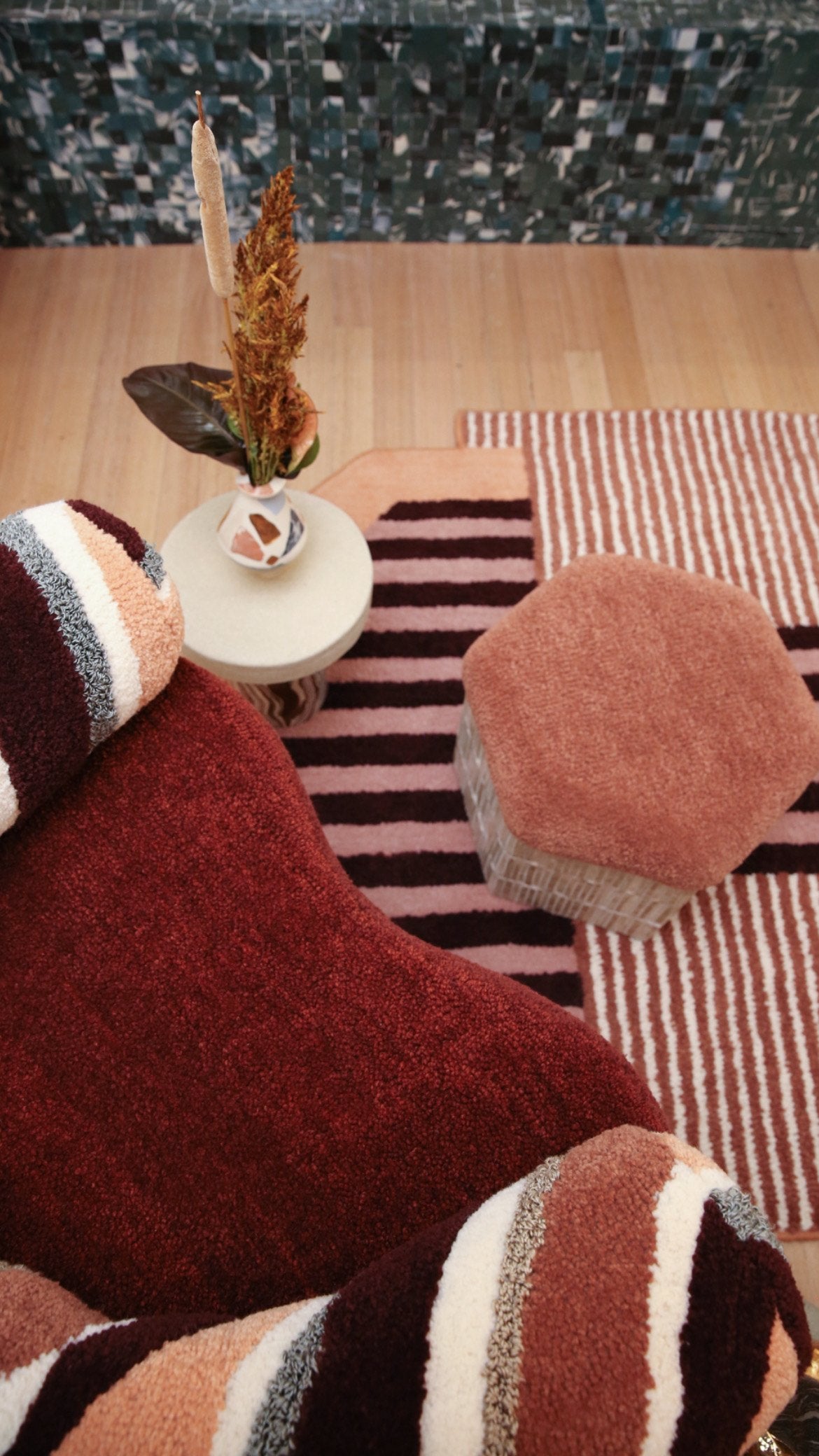 Tufted cushions, a striped rug and a hex footstool in FOND by Tantri Mustika and Megan McNeill, 2022