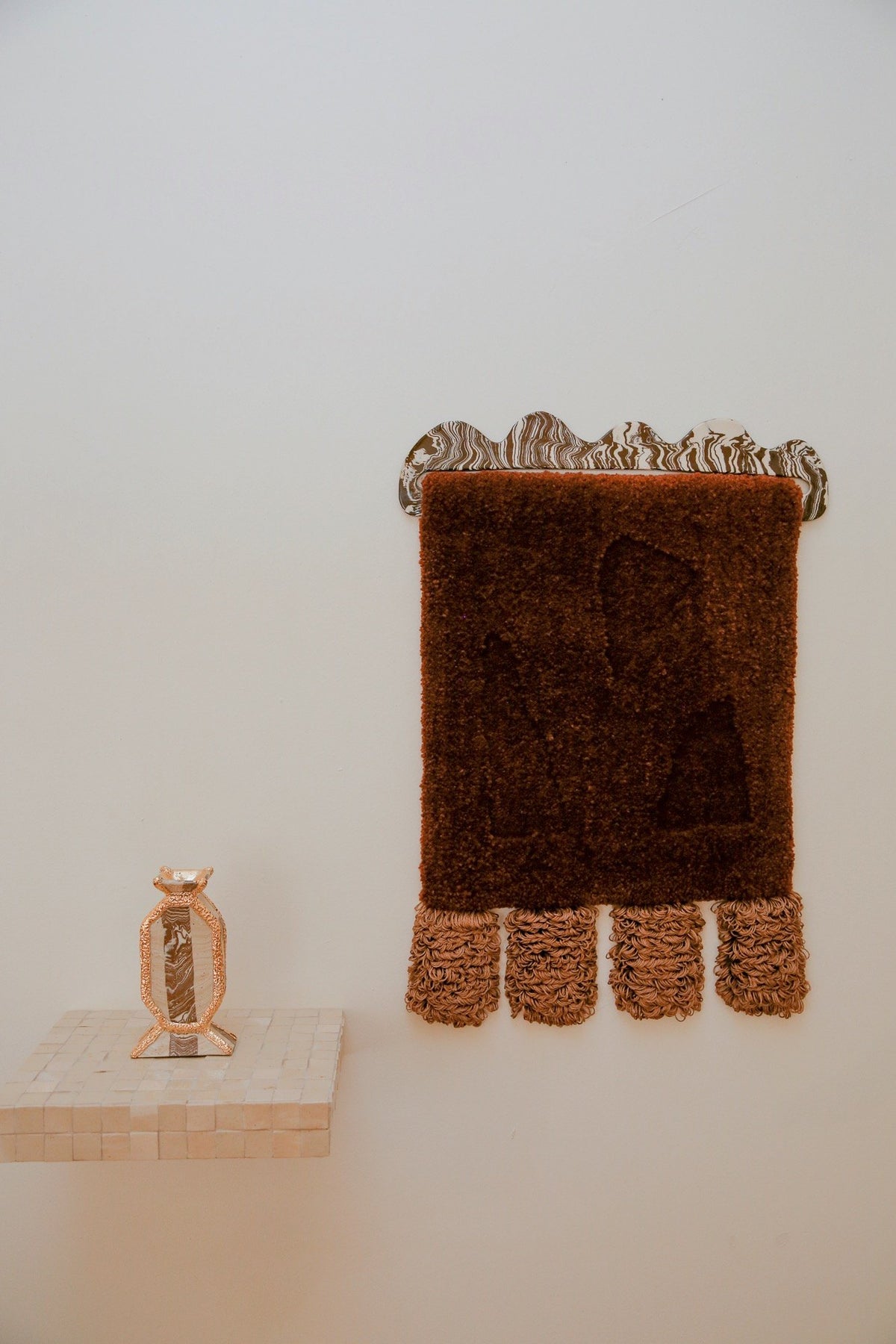 Formation wall hanging with a marbled ceramic top, beside a ceramic vase, FOND 2022