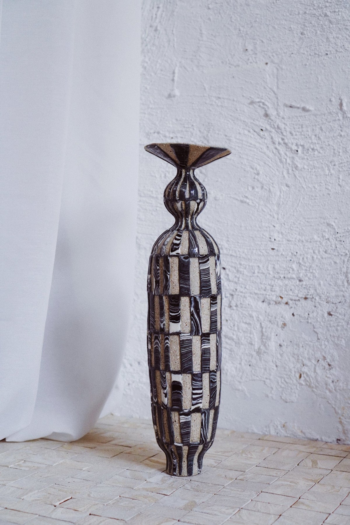 Checks and stripes on a tall bottle, Marmoreal, by Tantri Mustika