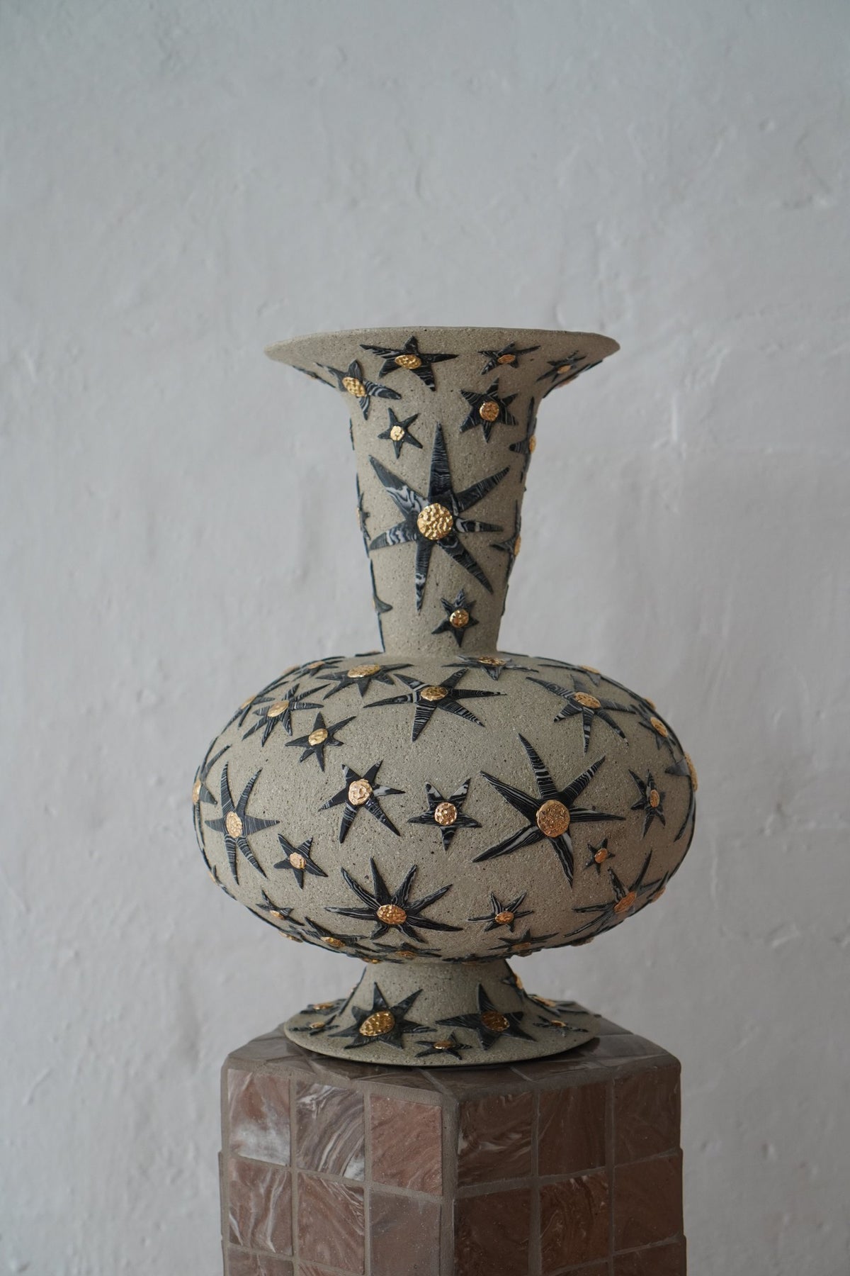 “It’s already written in the stars” #1 by Tantri Mustika on a tiled plinth, 2024