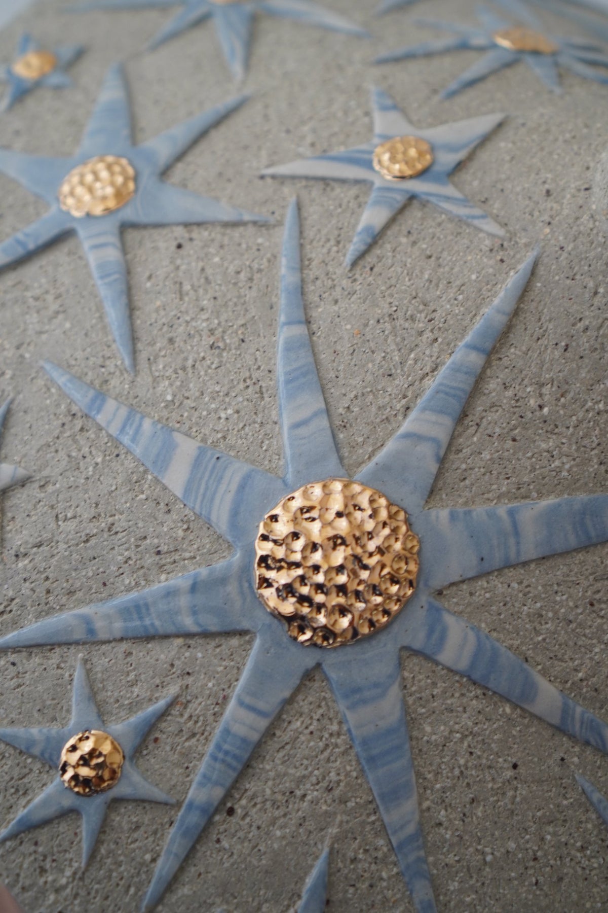 Detail of blue stars with gold lustre centres, “It’s already written in the stars” #2 by Tantri Mustika, 2024