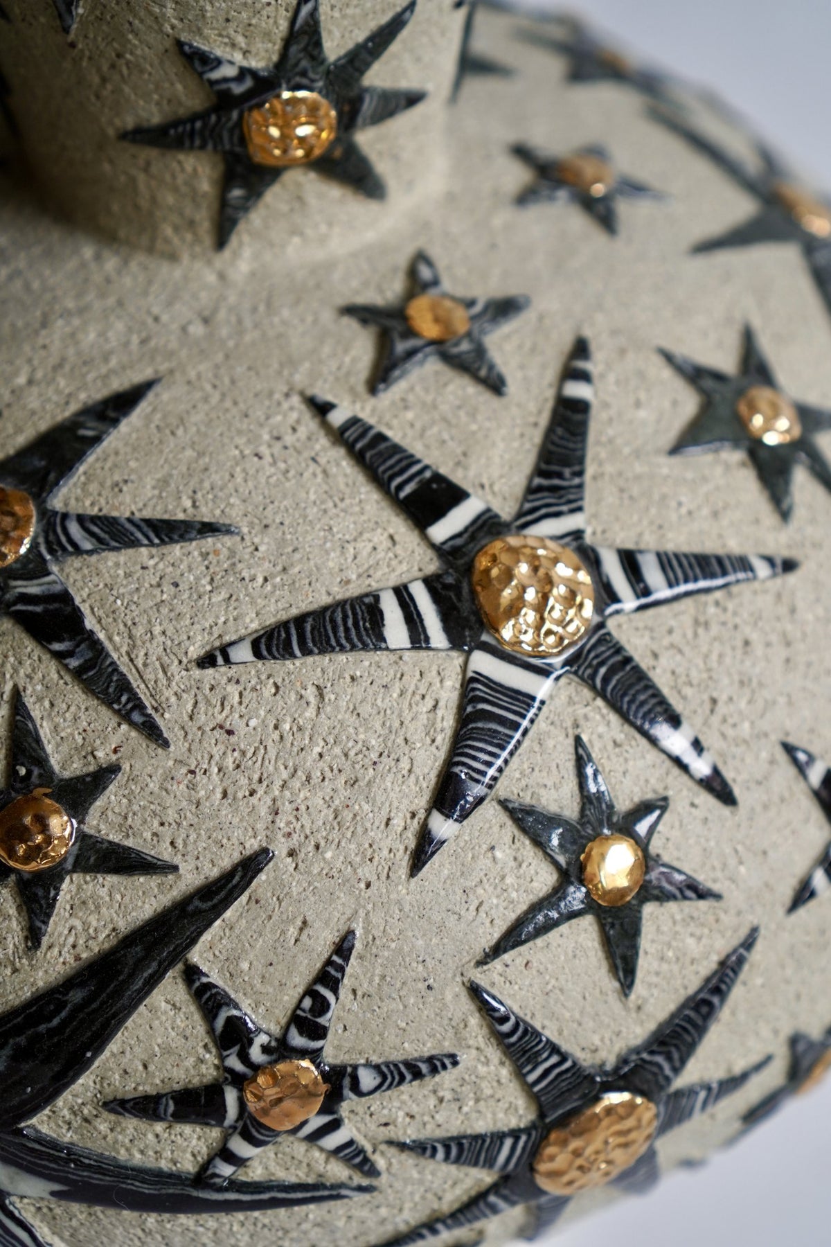 Detail of black and white stars with gold lustre centres, “It’s already written in the stars” #1 by Tantri Mustika, 2024