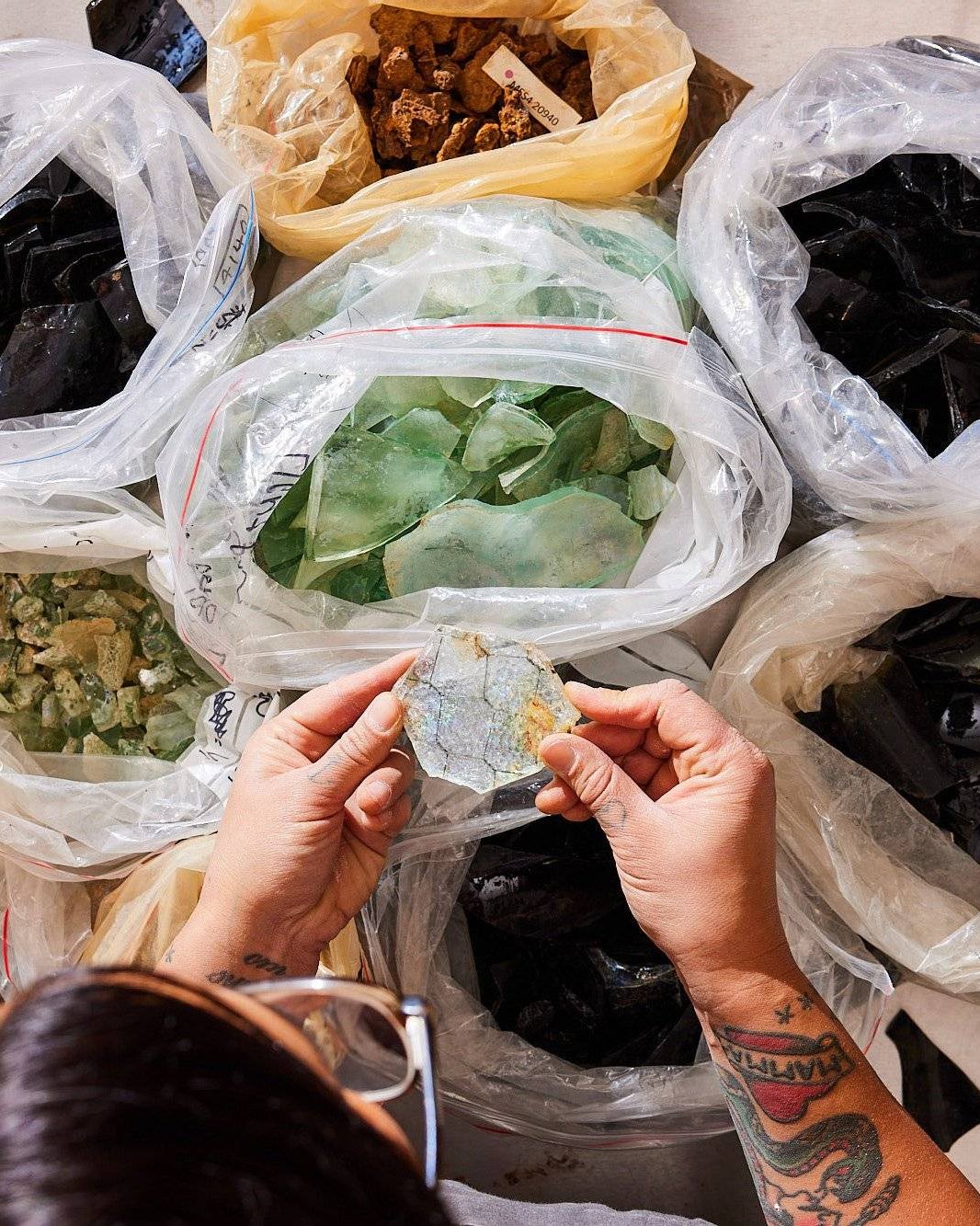 Sorting bags of glass fragments from the Metro Tunnel dig sites, Unearthed 2022