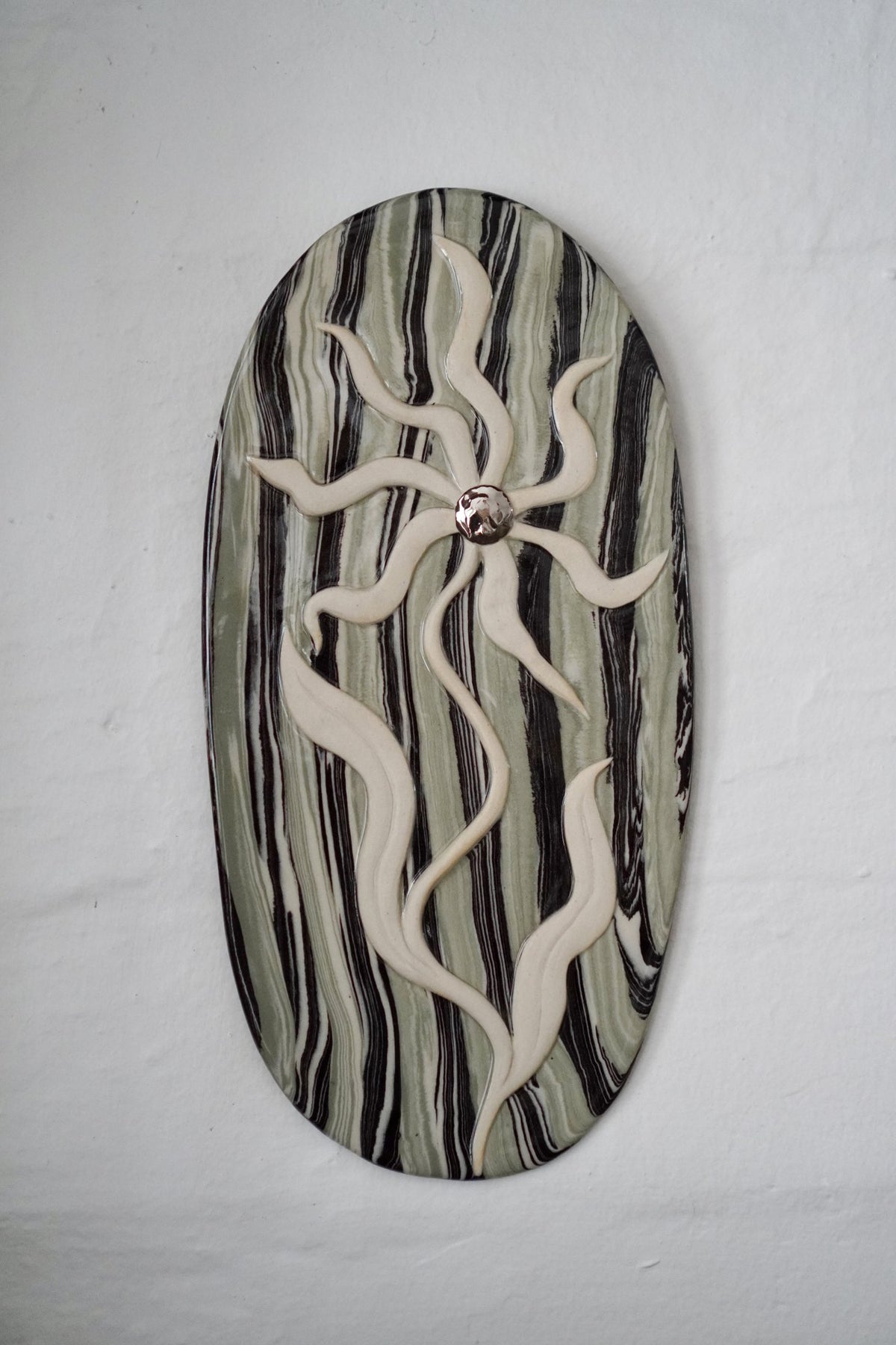 Carved ceramic wall plaque by Tantri Mustika