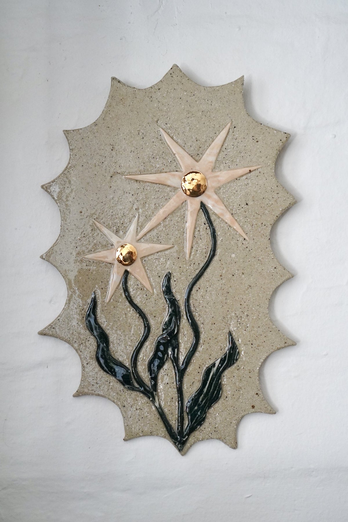 Carved ceramic wall plaque by Tantri Mustika